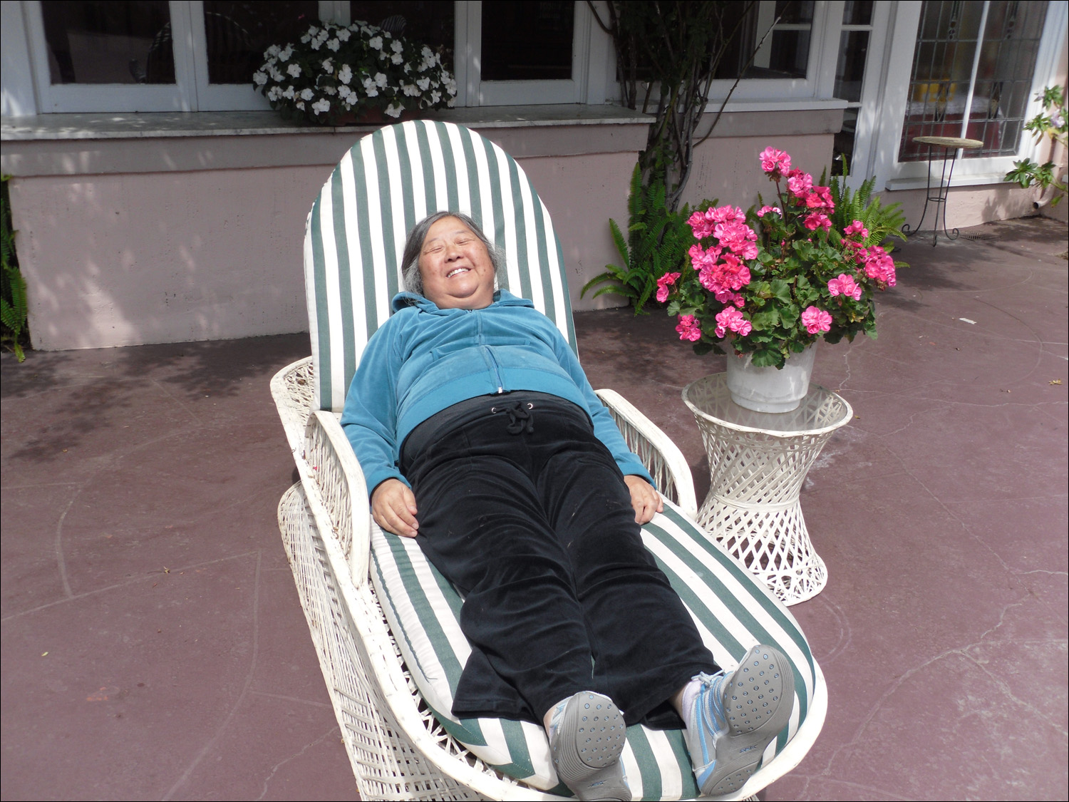 Lorene at rest on antique wicker lounge