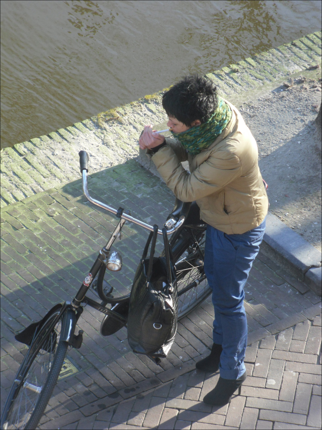 Lady bicyclist near canal