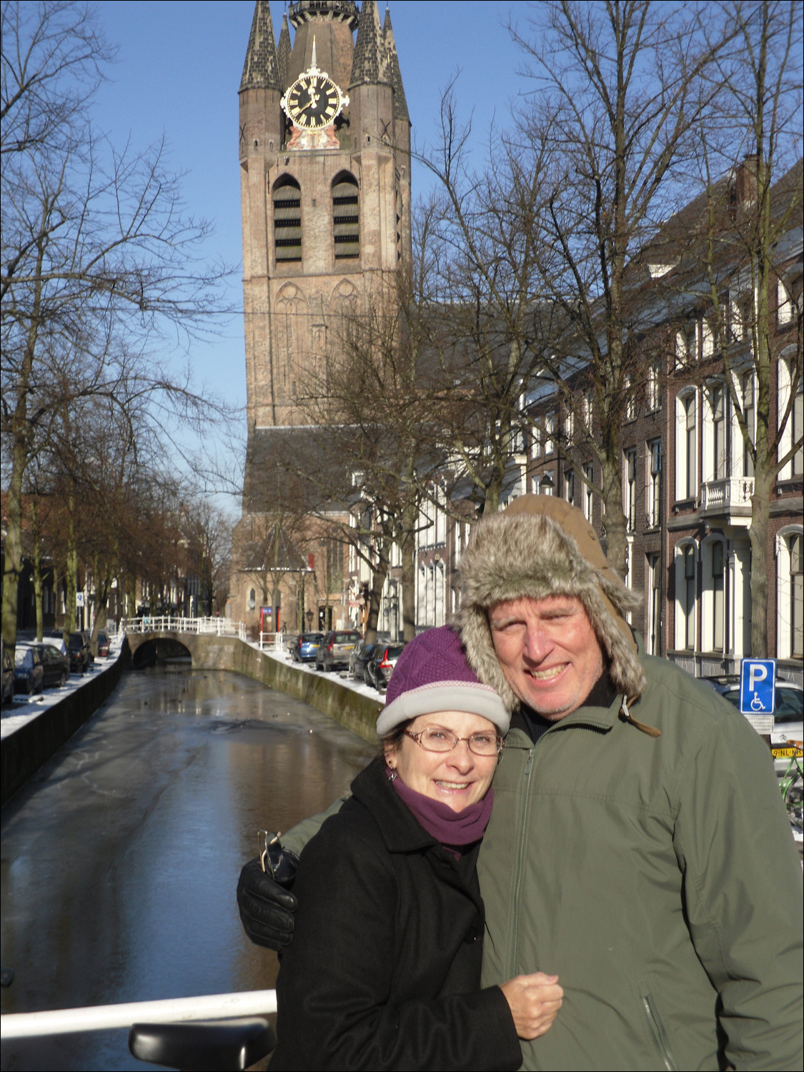 Delft-Bob & Kath in front of Oude Kerk (old church)-p.s. yes, it is leaning